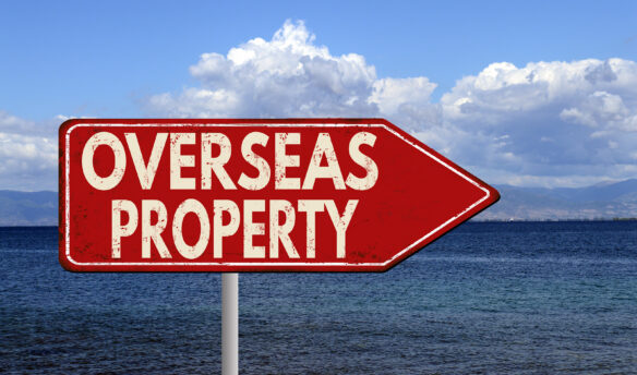 Overseas Property red sign with arrow pointing right