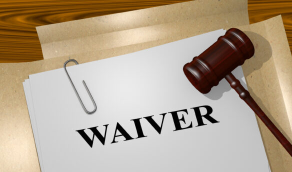 Waiver file folder with paperclip Judge's gavel on paper